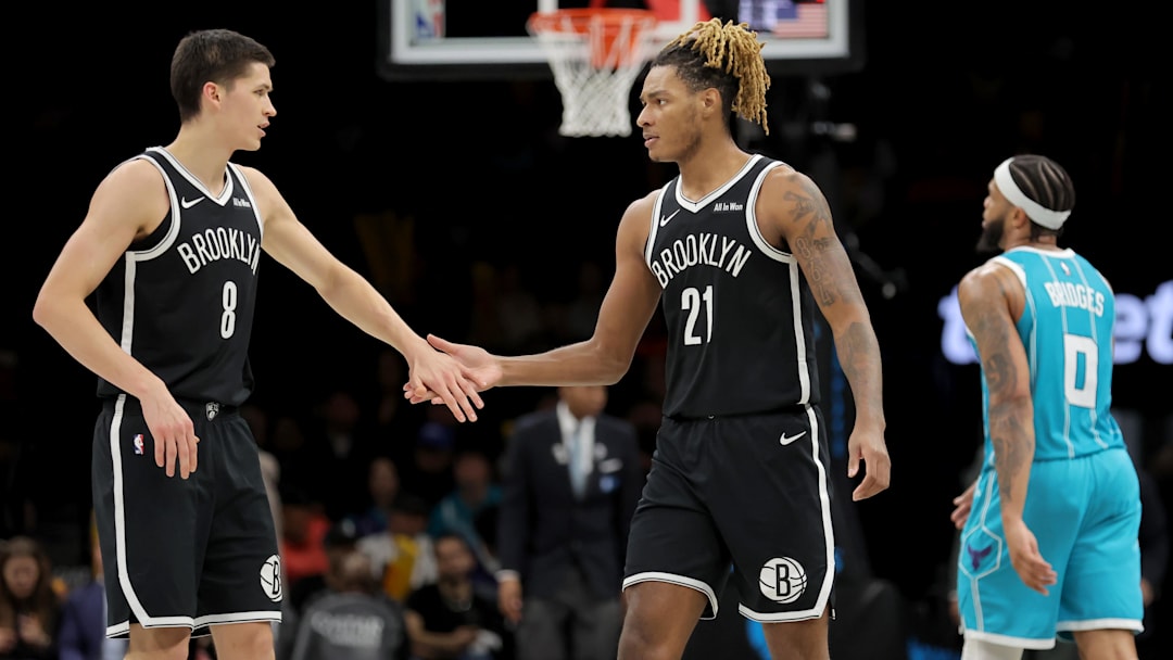 Dec 1, 2025; Brooklyn, New York, USA; Brooklyn Nets guard Egor Demin (8) high fives forward Noah Clowney (21) in front of Charlotte Hornets forward Miles Bridges (0) during the third quarter at Barclays Center. Mandatory Credit: Brad Penner-Imagn Images