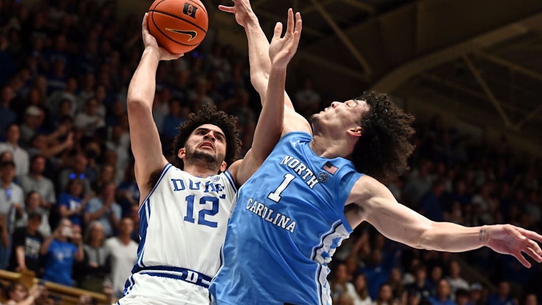 Mar 7, 2026; Durham, North Carolina, USA; Duke Blue Devils forward Cameron Boozer (12) shoots over North Carolina Tar Heels forward Zayden High (1) during the second half at Cameron Indoor Stadium.  The Duke Blue Devils won 76-61. Mandatory Credit: Rob Kinnan-Imagn Images