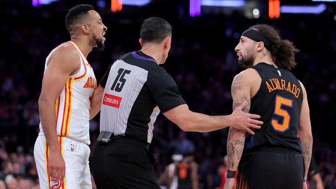 Apr 20, 2026; New York, New York, USA; Atlanta Hawks guard CJ McCollum (3) and New York Knicks guard Jose Alvarado (5) are separated by referee Zach Zarba (15) during the third quarter of game two of the first round of the 2026 NBA Playoffs at Madison Square Garden. Mandatory Credit: Brad Penner-Imagn Images