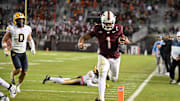 Oct 24, 2025; Blacksburg, V.; Virginia Tech quarterback Kyron Drones (1) runs for a touchdown against California.