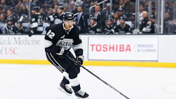 Caleb Jones skating with the puck during matchup between Utah Hockey Club v Los Angeles Kings