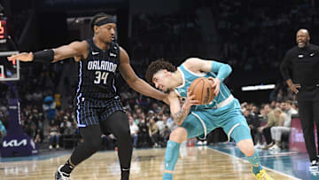 Mar 25, 2025; Charlotte, North Carolina, USA;  Charlotte Hornets guard LaMelo Ball (1) looks to drive past Orlando Magic center Wendell Carter Jr. (34) during the second half at the Spectrum Center. Mandatory Credit: Sam Sharpe-Imagn Images
