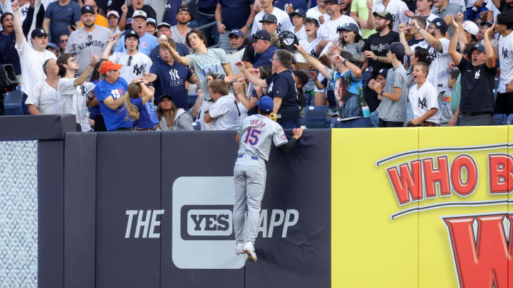 Jul 23, 2024; Bronx, New York, USA; New York Mets right fielder Tyrone Taylor (15) leaps but cannot catch a solo home run by New York Yankees second baseman Gleyber Torres (not pictured) during the second inning at Yankee Stadium. Mandatory Credit: Brad Penner-USA TODAY Sports