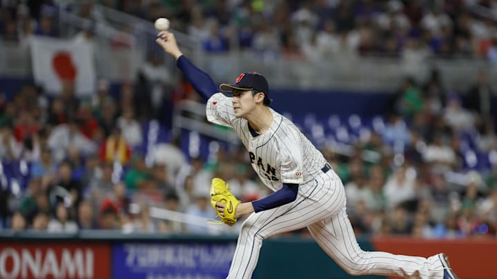 Mar 20, 2023; Miami, Florida, USA; Japan starting pitcher Roki Sasaki (14) delivers a pitch during the first inning against Mexico at LoanDepot Park. Mandatory Credit: Sam Navarro-Imagn Images
