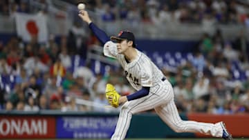 Mar 20, 2023; Miami, Florida, USA; Japan starting pitcher Roki Sasaki (14) delivers a pitch during the first inning against Mexico at LoanDepot Park. Mandatory Credit: Sam Navarro-Imagn Images