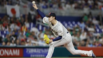 Mar 20, 2023; Miami, Florida, USA; Japan starting pitcher Roki Sasaki (14) delivers a pitch during the first inning against Mexico at LoanDepot Park. Mandatory Credit: Sam Navarro-Imagn Images