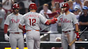 Philadelphia Phillies designated hitter Kyle Schwarber (12) celebrates with shortstop Trea Turner (right) and first baseman Bryce Harper (left) after hitting a home run during the fourth inning against the Arizona Diamondbacks in game four of the NLCS of the 2023 MLB playoffs at Chase Field in Phoenix on Oct. 20, 2023.