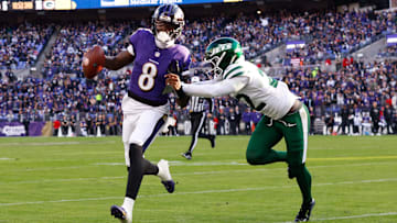 Nov 23, 2025; Baltimore, Maryland, USA; Baltimore Ravens quarterback Lamar Jackson (8) rushes as New York Jets safety Tony Adams (22) defends during the third quarter at M&T Bank Stadium. Mandatory Credit: Peter Casey-Imagn Images