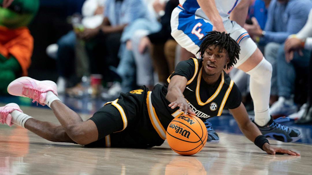 Missouri guard Anthony Robinson II (0) gets to the ball before Florida guard Walter Clayton Jr. (1) during the first half of their quarterfinal game of the SEC Men's Basketball Tournament at Bridgestone Arena in Nashville, Tenn., Friday, March 14, 2025.