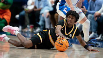 Missouri guard Anthony Robinson II (0) gets to the ball before Florida guard Walter Clayton Jr. (1) during the first half of their quarterfinal game of the SEC Men's Basketball Tournament at Bridgestone Arena in Nashville, Tenn., Friday, March 14, 2025.