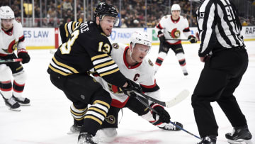 Mar 19, 2024; Boston, Massachusetts, USA;  Boston Bruins center Charlie Coyle (13) and Ottawa Senators left wing Brady Tkachuk (7) battle after a face off during the second period at TD Garden. Mandatory Credit: Bob DeChiara-USA TODAY Sports