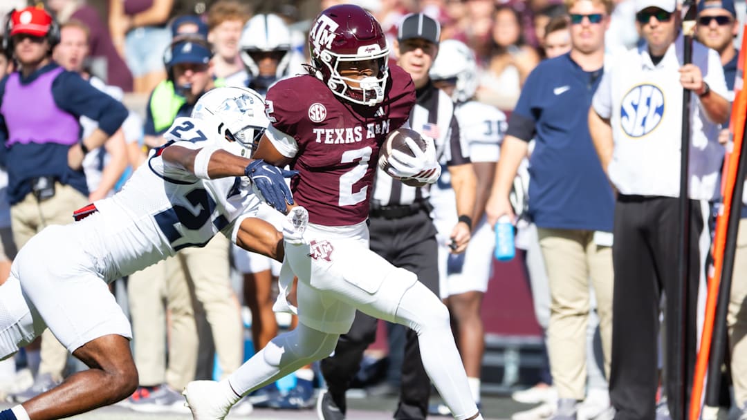 Nov 22, 2025; College Station, Texas, USA; Texas A&M Aggies wide receiver Terry Bussey (2) runs with the ball before being pushed out of bounds by Samford Bulldogs cornerback Gumbo Gaskins (27) in the first half of a game at Kyle Field. Mandatory Credit: Joseph Buvid-Imagn Images