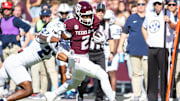 Nov 22, 2025; College Station, Texas, USA; Texas A&M Aggies wide receiver Terry Bussey (2) runs with the ball before being pushed out of bounds by Samford Bulldogs cornerback Gumbo Gaskins (27) in the first half of a game at Kyle Field. Mandatory Credit: Joseph Buvid-Imagn Images