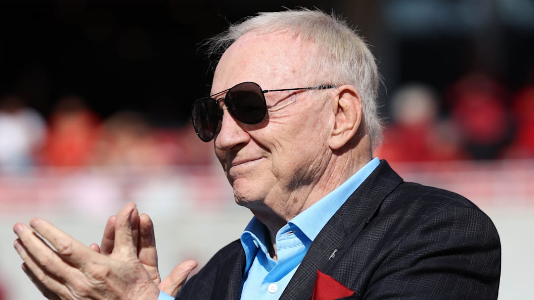 Nov 16, 2024; Fayetteville, Arkansas, USA; Dallas Cowboys owner and member of the 1964 Arkansas Razorbacks National Championship team, Jerry Jones, claps as the team is honored during the first half against the Texas Longhorns at Donald W. Reynolds Razorback Stadium. Mandatory Credit: Nelson Chenault-Imagn Images