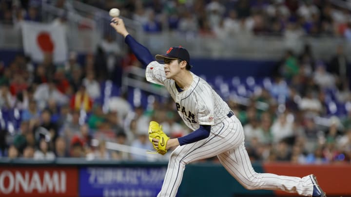 Mar 20, 2023; Miami, Florida, USA; Japan starting pitcher Roki Sasaki (14) delivers a pitch during the first inning against Mexico at LoanDepot Park.