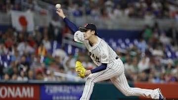 Mar 20, 2023; Miami, Florida, USA; Japan starting pitcher Roki Sasaki (14) delivers a pitch during the first inning against Mexico at LoanDepot Park. Mandatory Credit: Sam Navarro-Imagn Images