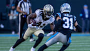 Nov 3, 2024; Charlotte, North Carolina, USA; New Orleans Saints running back Alvin Kamara (41) runs the ball against Carolina Panthers cornerback Caleb Farley (31) during the fourth quarter at Bank of America Stadium. Mandatory Credit: Scott Kinser-Imagn Images