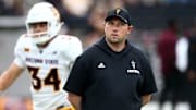 Sep 6, 2025; Starkville, Mississippi, USA; Arizona State Sun Devils head coach Kenny Dillingham looks on during warm ups prior to the game against the Mississippi State Bulldogs at Davis Wade Stadium at Scott Field. 