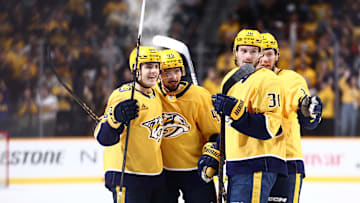 Oct 26, 2024; Nashville, Tennessee, USA; Nashville Predators celebrate with defenseman Alexandre Carrier (45) after a goal in the third period against the Columbus Blue Jackets at Bridgestone Arena. Mandatory Credit: Casey Gower-Imagn Images