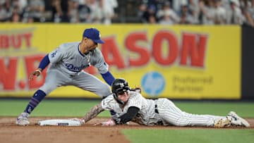 Jun 8, 2024; Bronx, New York, USA; New York Yankees left fielder Alex Verdugo (24) dives safely in to second base beating the tag by Los Angeles Dodgers shortstop Mookie Betts (50) during the fifth inning at Yankee Stadium. Mandatory Credit: Vincent Carchietta-Imagn Images