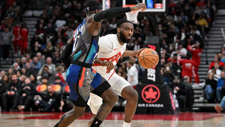 Mar 25, 2024; Toronto, Ontario, CAN;  Toronto Raptors guard Javon Freeman-Liberty (0) dribbles Dennis Schröder