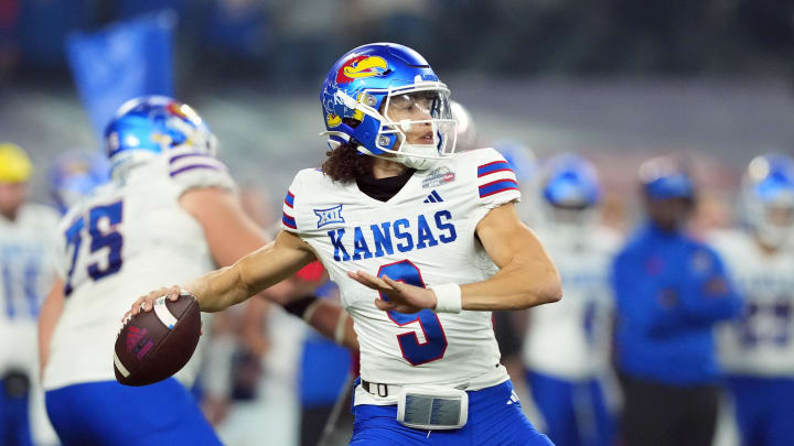 Dec 26, 2023; Phoenix, AZ, USA; Kansas Jayhawks quarterback Jason Bean (9) passes against the UNLV Rebels during the first half at Chase Field. Mandatory Credit: Joe Camporeale-USA TODAY Sports