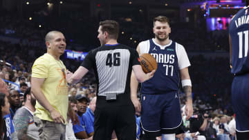 May 7, 2024; Oklahoma City, Oklahoma, USA; An official talks to a fan after he heckled Dallas
