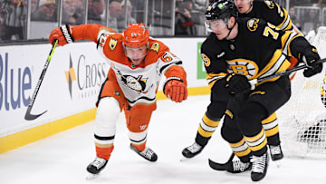 Oct 23, 2025; Boston, Massachusetts, USA; Anaheim Ducks center Mikael Granlund (64) and Boston Bruins defenseman Michale Callahan (79) battle for the puck during the second period at TD Garden. Mandatory Credit: Bob DeChiara-Imagn Images