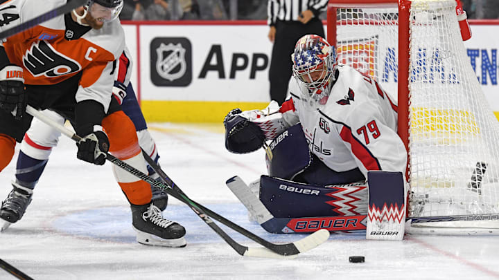 Feb 6, 2025; Philadelphia, Pennsylvania, USA; Philadelphia Flyers center Sean Couturier (14) battles for the pick against Washington Capitals goaltender Charlie Lindgren (79) during the third period at Wells Fargo Center. Mandatory Credit: Eric Hartline-Imagn Images