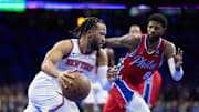 Nov 12, 2024; Philadelphia, Pennsylvania, USA; New York Knicks guard Jalen Brunson (11) drives in front of Philadelphia 76ers forward Paul George (8) during the second quarter at Wells Fargo Center. Mandatory Credit: Bill Streicher-Imagn Images