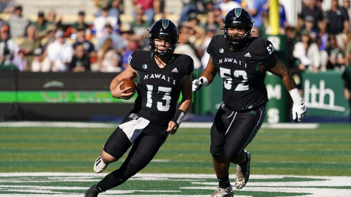 Oct 22, 2022; Fort Collins, Colorado, USA; Hawaii Warriors quarterback Brayden Schager (13) runs for a gain in the first quarter  at Sonny Lubick Field at Canvas Stadium. Mandatory Credit: Michael Madrid-USA TODAY Sports