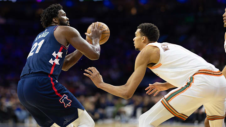 Jan 22, 2024; Philadelphia, Pennsylvania, USA; Philadelphia 76ers center Joel Embiid (21) shoots against San Antonio Spurs center Victor Wembanyama (1) during the second quarter at Wells Fargo Center. Mandatory Credit: Bill Streicher-Imagn Images