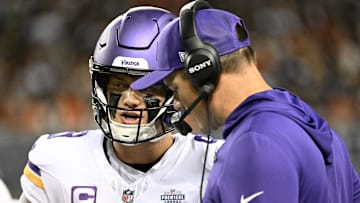 Minnesota Vikings head coach Kevin O'Connell talks with quarterback J.J. McCarthy (9) during the first half at Soldier Field