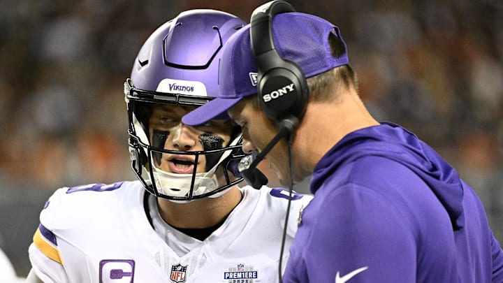Minnesota Vikings head coach Kevin O'Connell talks with quarterback J.J. McCarthy (9) during the first half at Soldier Field