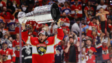 Jun 24, 2024; Sunrise, Florida, USA; Florida Panthers defenseman Brandon Montour (62) lifts the cup after winning game seven of the 2024 Stanley Cup Final against the Edmonton Oilers at Amerant Bank Arena. Mandatory Credit: Sam Navarro-USA TODAY Sports