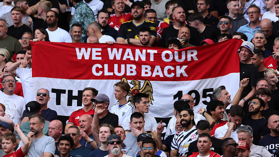 Man Utd’s supporters unfurl a banner reading ‘we want our club back’ at Fulham.