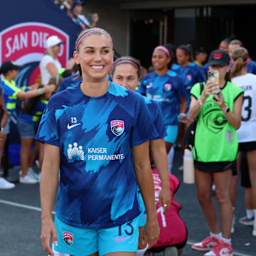 San Diego Wave FC forward Alex Morgan walks onto the pitch for her final game