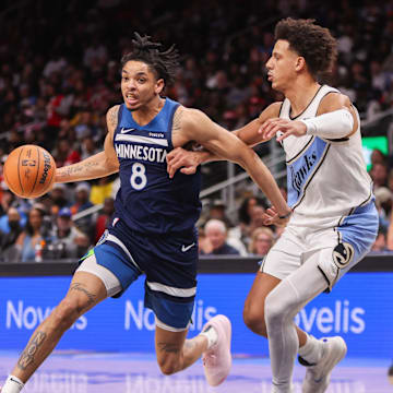 Dec 23, 2024; Atlanta, Georgia, USA; Minnesota Timberwolves forward Josh Minott (8) drives on Atlanta Hawks forward Jalen Johnson (1) in the fourth quarter at State Farm Arena. Mandatory Credit: Brett Davis-Imagn Images