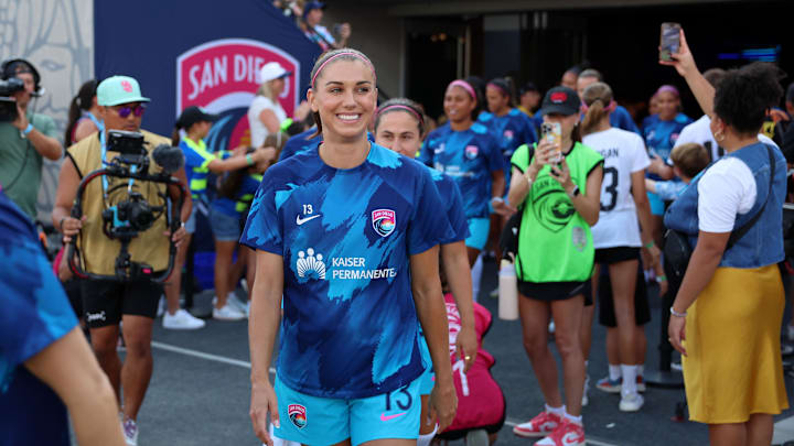 San Diego Wave FC forward Alex Morgan walks onto the pitch for her final game