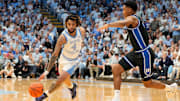 Mar 8, 2025; Chapel Hill, North Carolina, USA;  North Carolina Tar Heels guard RJ Davis (4) with the ball as Duke Blue Devils guard Caleb Foster (1) defends in the second half at Dean E. Smith Center. Mandatory Credit: Bob Donnan-Imagn Images