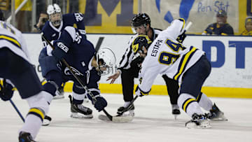 March 8, 2025; Ann Arbor, Michigan, USA; Penn State forward Charlie Cerrato (15) and Michigan Wolverines forward Mark Estapa (94) face of during the second period at Yost Ice Arena. Mandatory Credit: Brian Bradshaw Sevald-Imagn Images
