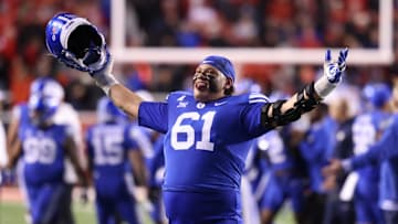 Nov 9, 2024; Salt Lake City, Utah, USA; Brigham Young Cougars offensive lineman Weylin Lapuaho (61) celebrates after defeating the Utah Utes at Rice-Eccles Stadium. Mandatory Credit: Rob Gray-Imagn Images