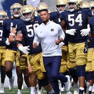 Sep 16, 2023; South Bend, Indiana, USA; Notre Dame Fighting Irish head coach Marcus Freeman leads his players onto the field for the game against the Central Michigan Chippewas at Notre Dame Stadium.