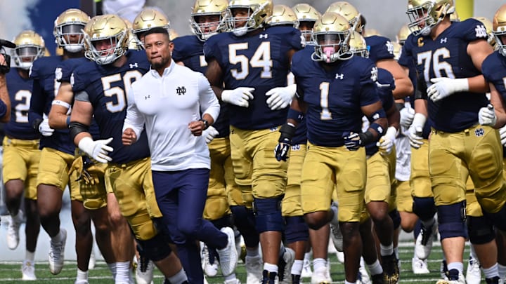 Sep 16, 2023; South Bend, Indiana, USA; Notre Dame Fighting Irish head coach Marcus Freeman leads his players onto the field for the game against the Central Michigan Chippewas at Notre Dame Stadium.