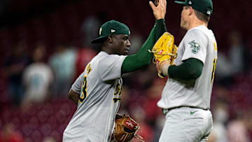 Oakland Athletics left fielder Daz Cameron (28) high fives Oakland Athletics pitcher Mason Miller (19) after the MLB game at Great American Ball Park in Cincinnati on Wednesday, Aug. 28, 2024. Oakland Athletics defeated Cincinnati Reds 9-6.