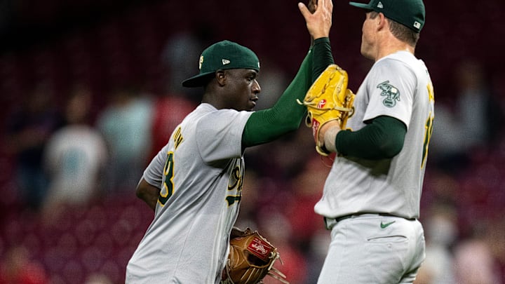 Oakland Athletics left fielder Daz Cameron (28) high fives Oakland Athletics pitcher Mason Miller (19) after the MLB game at Great American Ball Park in Cincinnati on Wednesday, Aug. 28, 2024. Oakland Athletics defeated Cincinnati Reds 9-6.