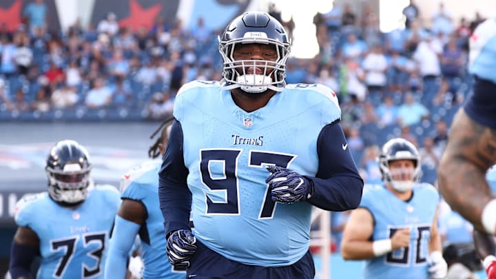 Aug 17, 2024; Nashville, Tennessee, USA; Tennessee Titans defensive tackle Quinton Bohanna (97) and teammates run onto the field before the game against the Seattle Seahawks at Nissan Stadium. Mandatory Credit: Casey Gower-Imagn Images