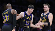 Nov 18, 2025; Los Angeles, California, USA; Los Angeles Lakers guard Austin Reaves (15) is congratulated by forward LeBron James (23) and guard Luka Doncic (77) after a three-point basket in the second quarter at Crypto.com Arena. Mandatory Credit: Kirby Lee-Imagn Images