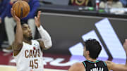 Dec 3, 2025; Cleveland, Ohio, USA; Cleveland Cavaliers guard Donovan Mitchell (45) shoots against Portland Trail Blazers forward Deni Avdija (8) in the fourth quarter at Rocket Arena. Mandatory Credit: David Richard-Imagn Images