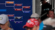 Fans walk past the SEC softball tournament bracket after Georgia fell to Arkansas in Athens, Ga., on Wednesday, May 7, 2025. Arkansas won 5-1.